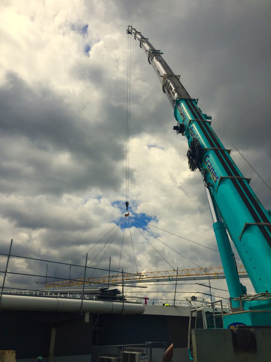 Crane lifting roofing materials onto the Archives building