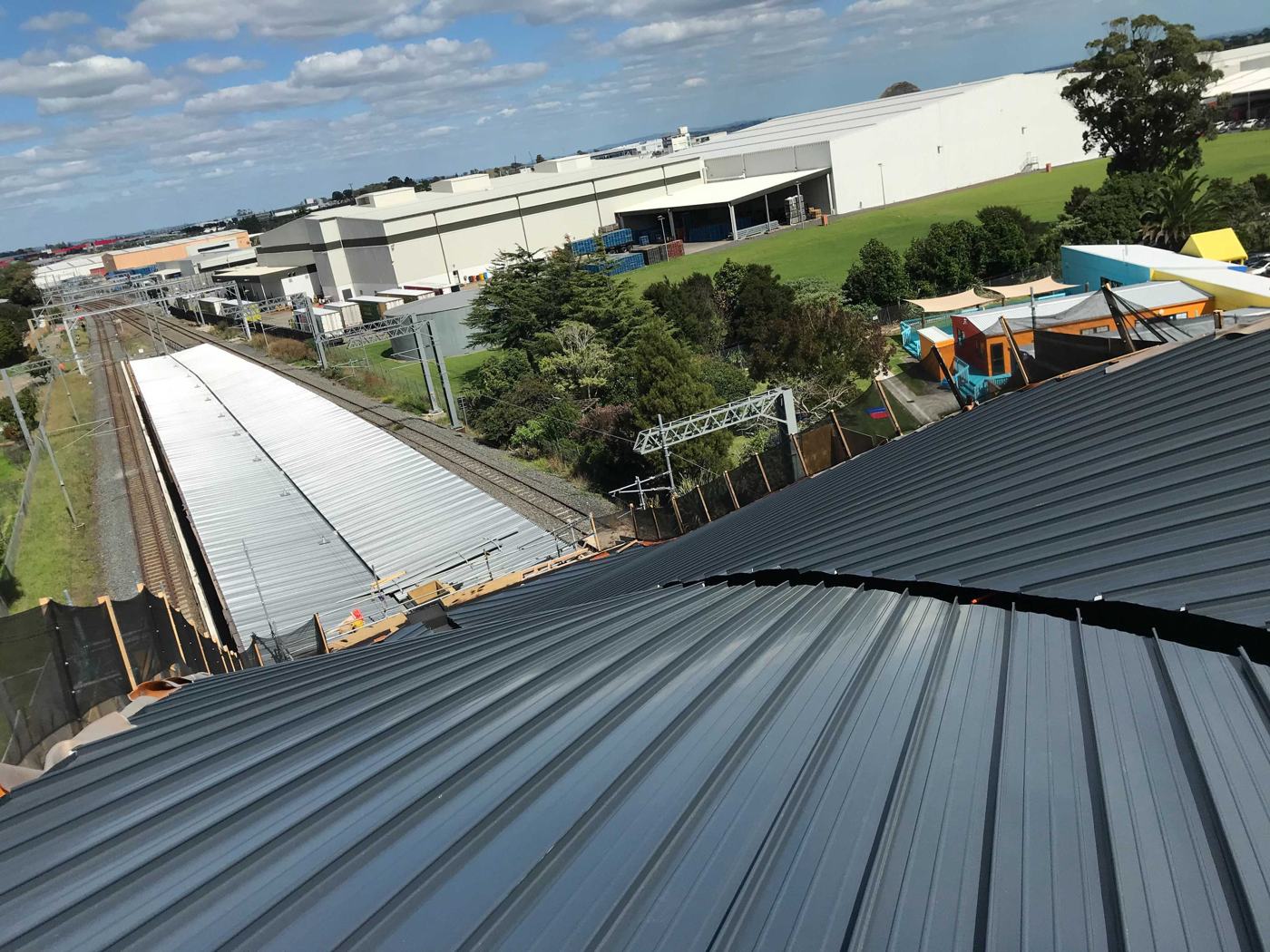 Standing seam roof at Puhinui with the rail corridor below