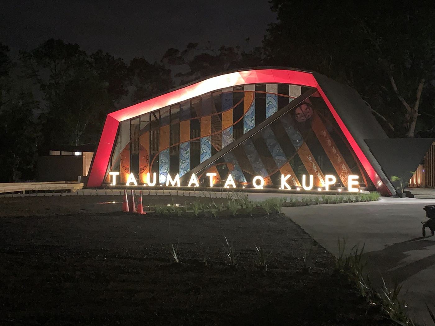 Taumata o Kupe lit at night with its name in lights